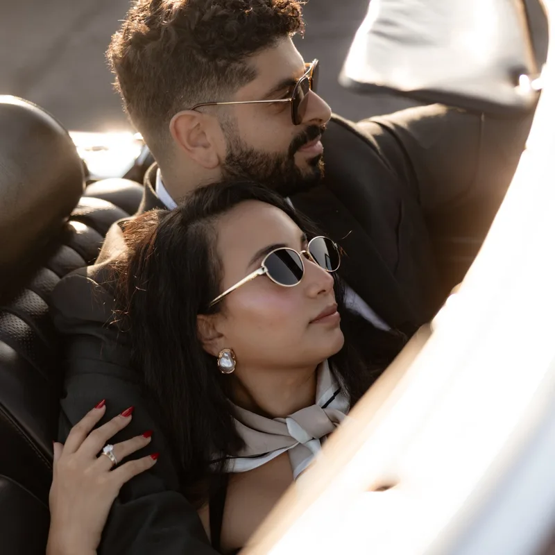 David and Joy close together in the convertible, the engagement ring catching the light